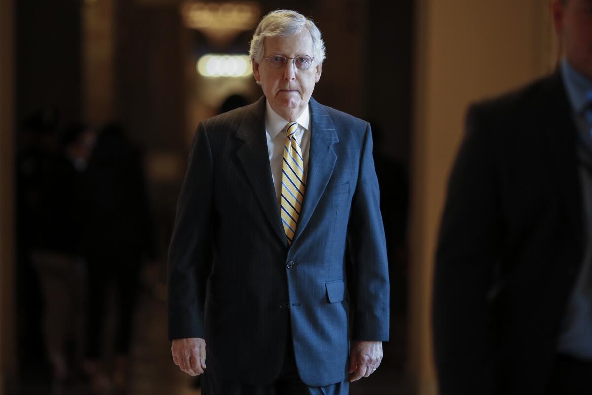 Senate Majority Leader Mitch McConnell (R-Ky.) walks a corridor in the Capitol