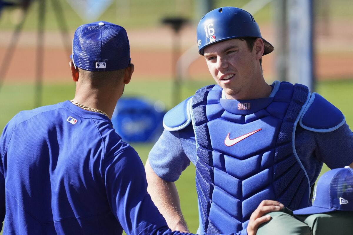 Dodgers catcher Will Smith, right, talks with Mookie Betts during a spring training workout on Monday.