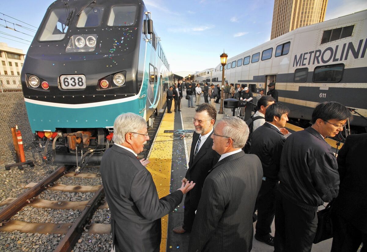 In this photo from 2010, Arthur T. Leahy, left, Metro's chief executive, chats with other transit officials at Union Station after Metrolink unveiled its new state-of-the-art cab and passenger rail cars equipped with collision-absorption technology.