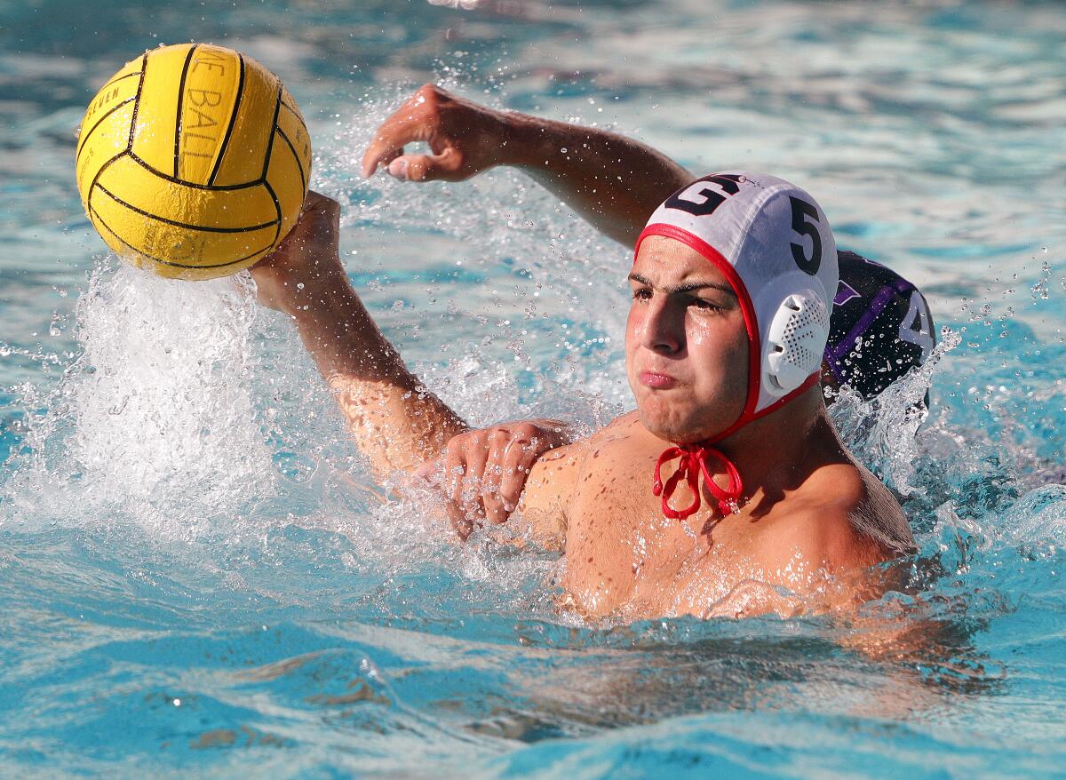 Glendale's Hagop Duvenjian shoots with his arm being grabbed by Hoover's Hayk Nazaryan in a Pacific League boys' water polo match at Hoover High School on Wednesday, October 23, 2019. Hoover defeated Glendale 12-11 after coming from behind in the fourth quarter to win the match.