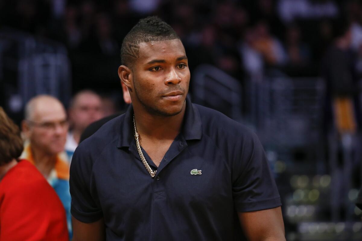Dodgers outfielder Yasiel Puig watches the Lakers play the Dallas Mavericks at Staples Center on Tuesday. Last season, Puig twice went on the disabled list with strained hamstrings, appearing in only 79 games.