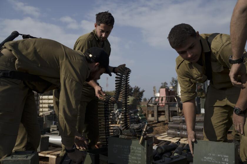 Israeli soldiers store ammunition in a staging area at the Israeli-Gaza border in southern Israel, Tuesday, Jan. 2, 2024. The army said Monday that several thousand troops would be taken out of Gaza in the coming weeks. Some will head to bases for further training or rest, while many older reservists will go home. (AP Photo/Leo Correa)