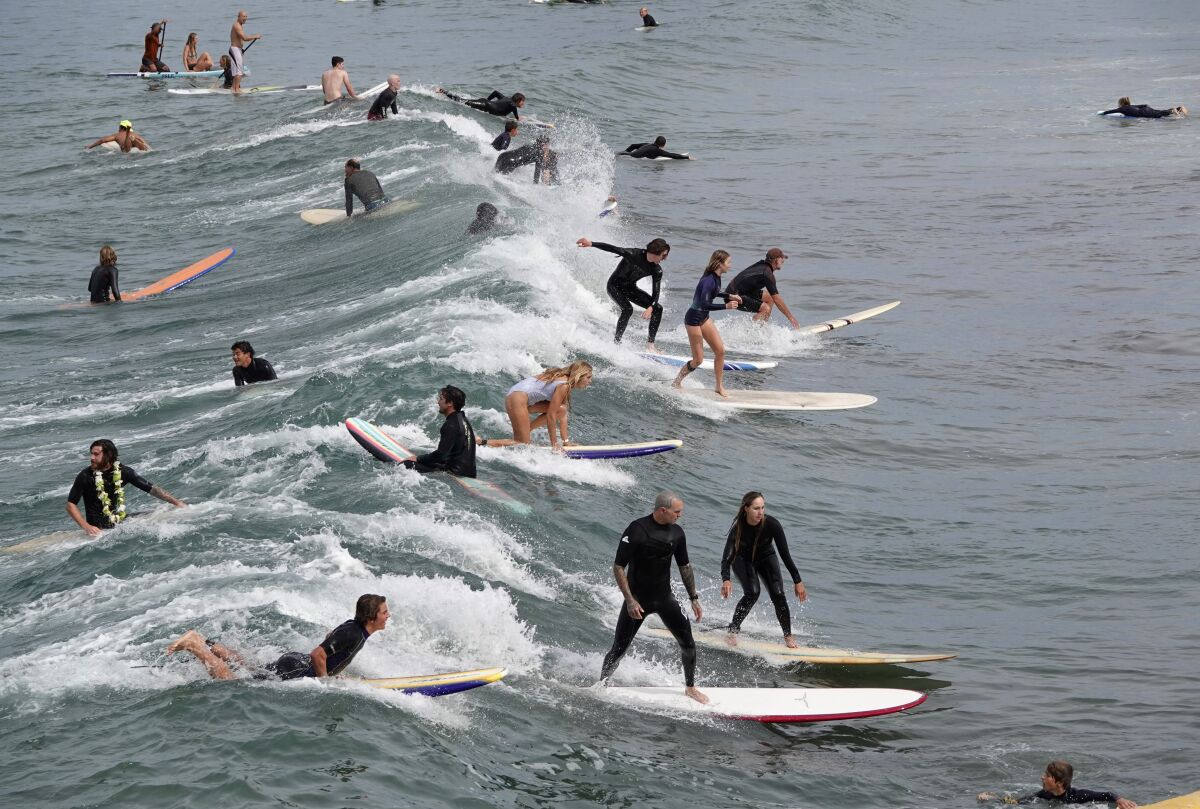 Surfers catch a wave in Ocean Beach
