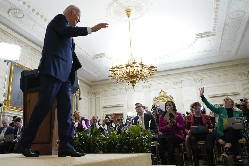 President Joe Biden gestures as he leaves the podium at the end of a news conference in the White House