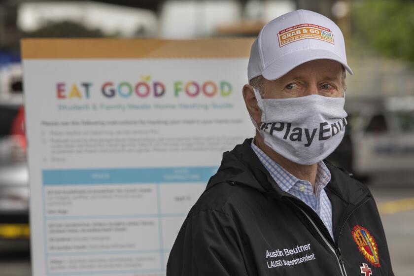 SAN FERNANDO, CA-APRIL 20, 2020: LAUSD Superintendent Austin Beutner wears a protective mask against the coronavirus, during a tour of one of the district's Grab & Go food centers at San Fernando Senior High School, where meals were given out to LAUSD students in need. (Mel Melcon/Los Angeles Times)