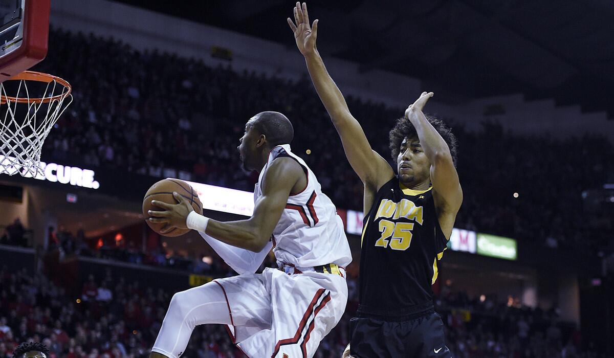 Maryland's Rasheed Sulaimon, left, drives to the basket around Iowa's Dom Uhl in the second half on Thursday.