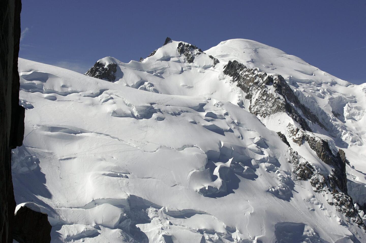 A 2005 photo shows Mont Maudit and the Mont Blanc main peak, right rear, above Chamonix, France. An avalanche Thursday swept climbers from several European countries to their deaths on a slope leading to Mont Blanc.