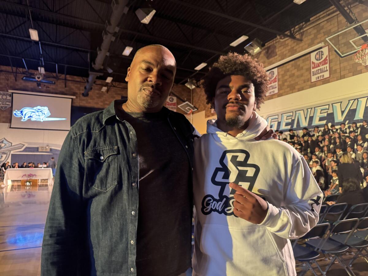 Michael Wynn (left), who was a star quarterback at San Fernando High, poses for a photo with his son, Michael Jr.