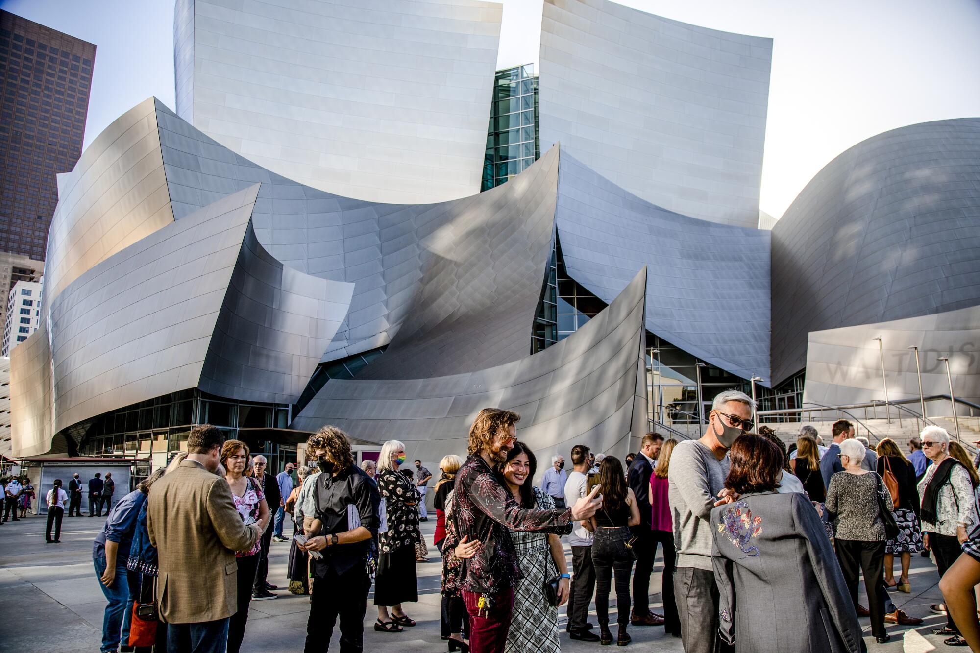 The exterior of Walt Disney Concert Hall with people gathered outside.