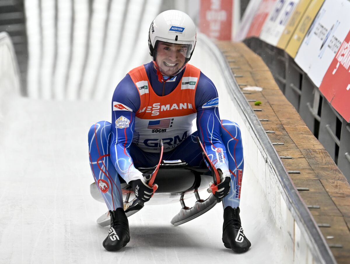 FILE - In this Feb. 16, 2020, file photo, Tucker West, of United States, finishes his team relay race at the World Luge Championships in Krasnaya Polyana, near the Black Sea resort of Sochi, southern Russia. The USA Luge Olympic veteran got the first run down the ice at Mount Van Hoevenberg in Lake Placid, N.Y., on Thursday, Oct. 14, 2021, when the Americans’ home track opened for the season. (AP Photo/Artur Lebedev, File)