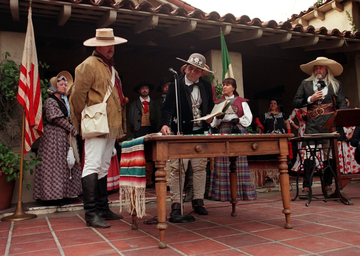Actors in historical clothing re-create the signing of a treaty