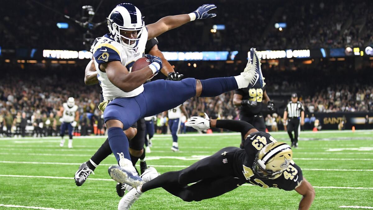 Rams running back Malcolm Brown, leaping over New Orleans Saints safety Marcus Williams, is sidelined because of a clavicle injury suffered against the Detroit Lions.