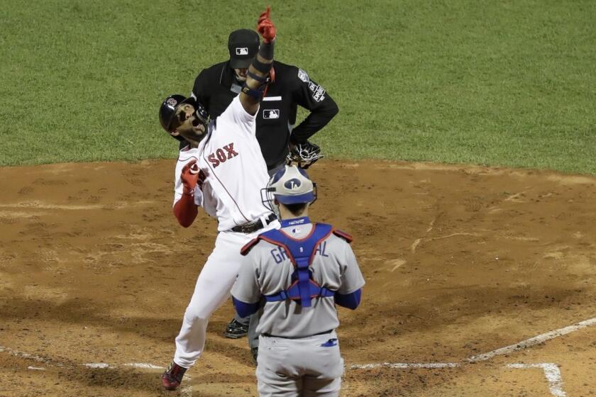 Boston Red Sox's Eduardo Nunez reacts after hitting a three-run home run during the seventh inning of Game 1 of the World Series baseball game against the Los Angeles Dodgers Tuesday, Oct. 23, 2018, in Boston. (AP Photo/David J. Phillip)