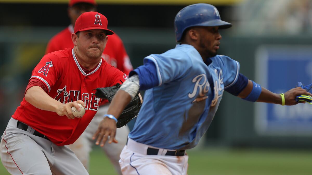 Angels pitcher Cory Rasmus chases down Kansas City baserunner Alcides Escobar during the fifth inning of the Angels' 5-4 loss Sunday.