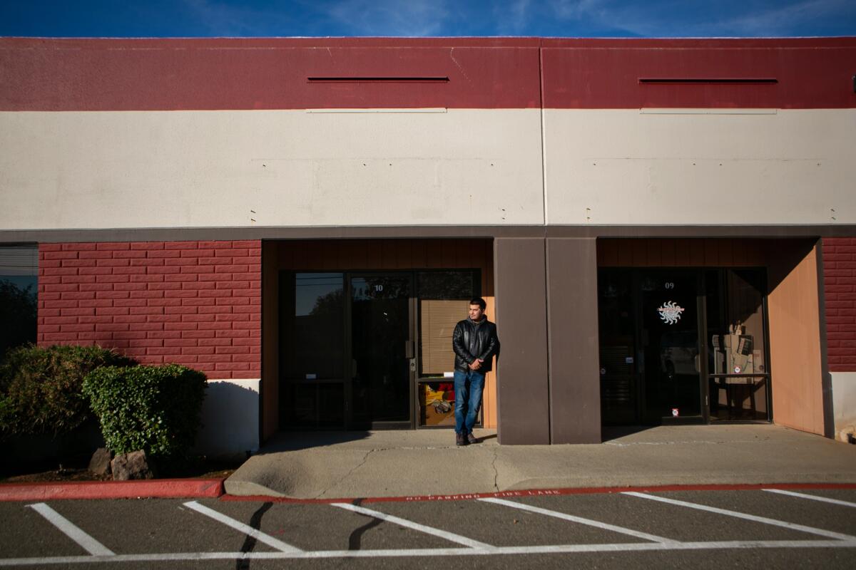 Emal Salarzai stands outside his his e-commerce business in Sacramento.