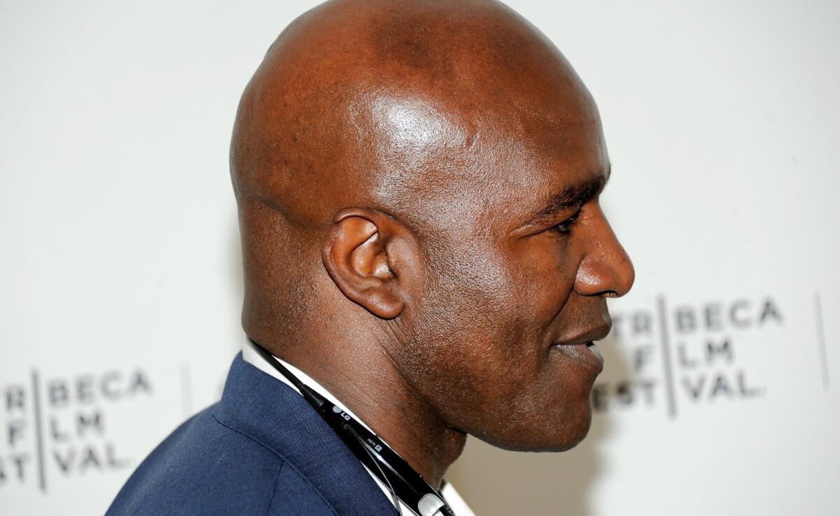 Retired heavyweight boxer Evander Holyfield displays a little less ear than he was born with. Holyfield, who had part of his ear bitten off by Mike Tyson in 1997, sympathizes with Dodgers infielder Alex Guerrero, who recently had a larger part of his ear bitten off by a teammate.