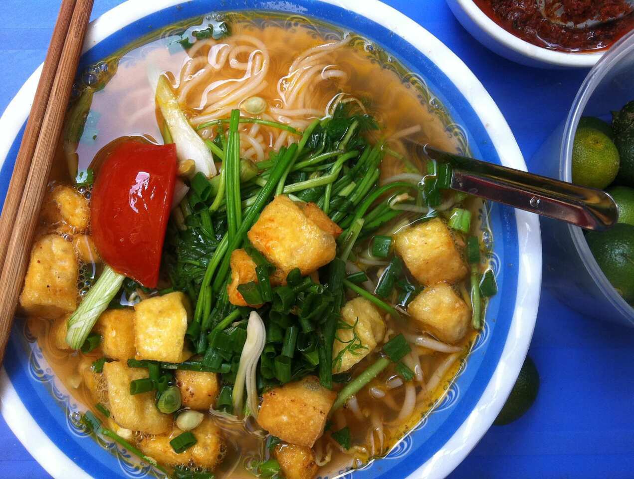 A bowl of bun dau is served at a street stall in Hanoi's Old Quarter. The light noodle soup with tomatoes, crunchy greens and tender little pillows of fried tofu makes for a satisfying lunch.