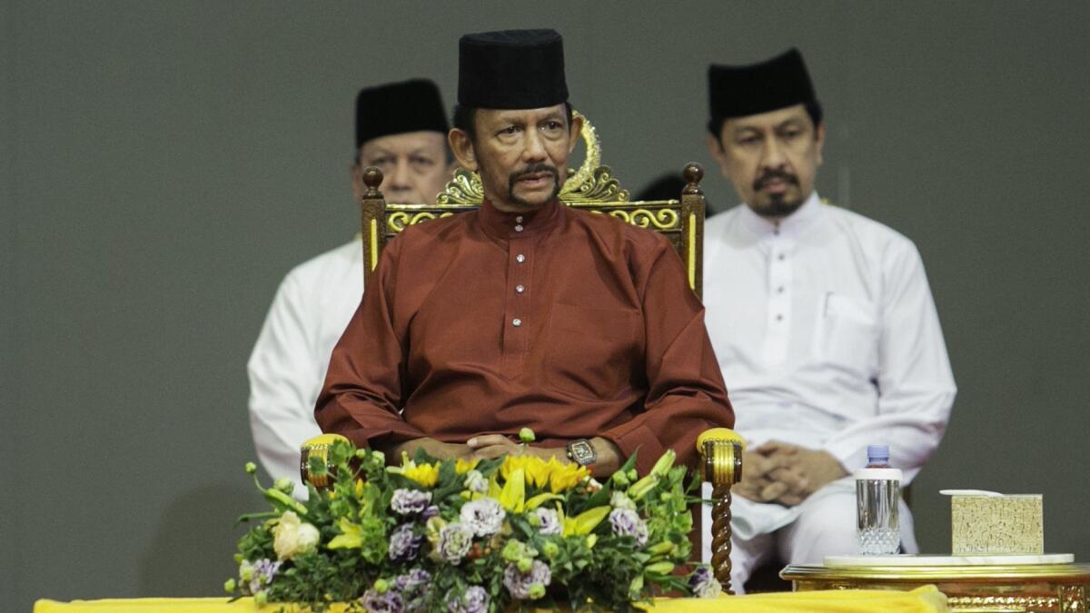 Brunei's sultan has announced that death by stoning for gay sex and adultery will not be enforced after a global backlash, but critics on Monday called for harsh sharia laws to be abandoned entirely.