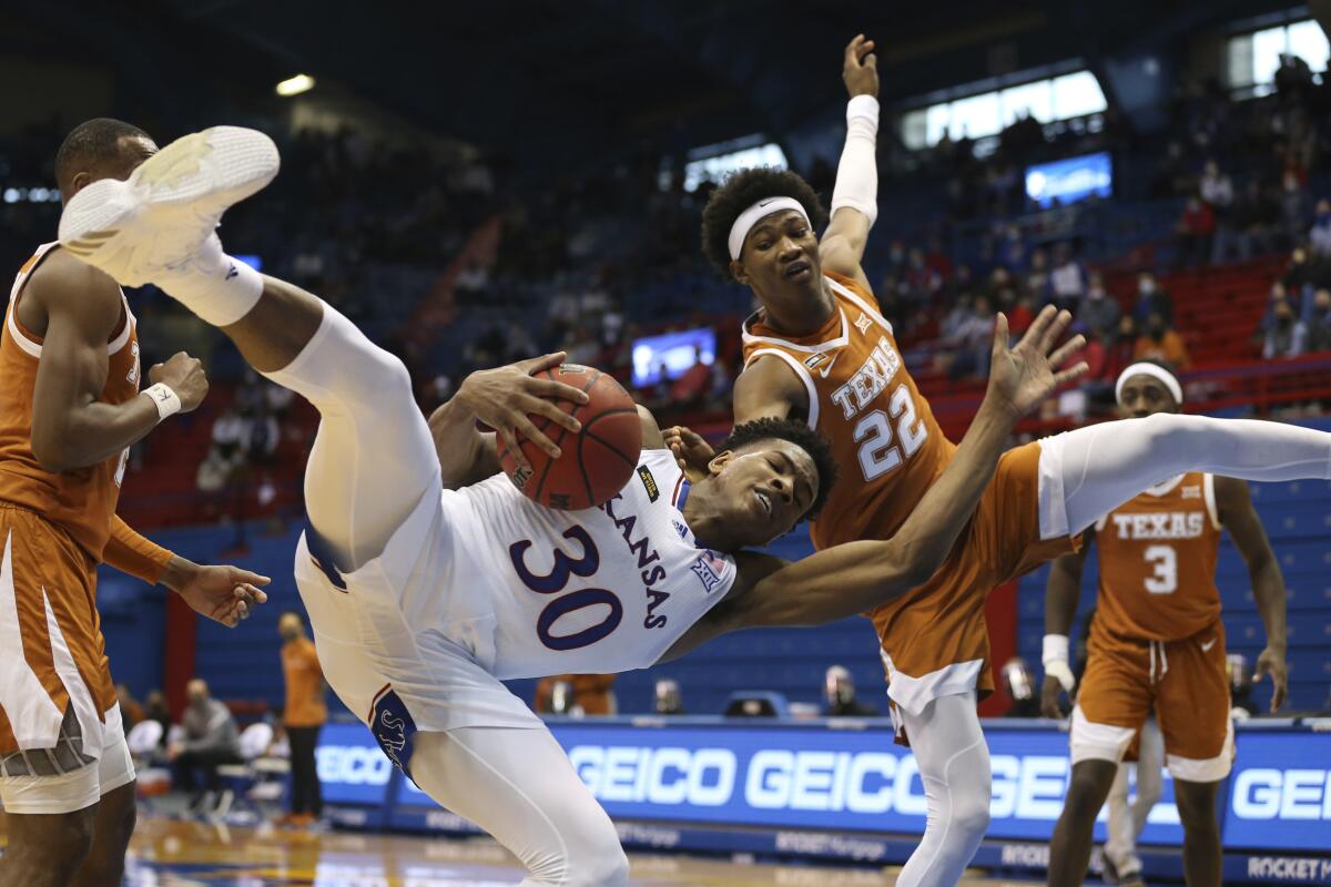 Kansas guard Ochai Agbaji holds on to a rebound against Texas forward Kai Jones on Jan. 2. 2021, in Lawrence, Kan.