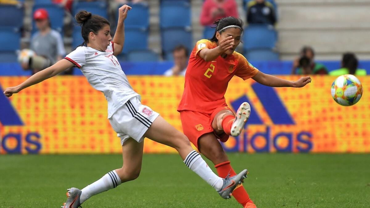 Spain forward Lucia Garcia, left, battles with China defender Shanshan Liu during a Women's World Cup group play match in France on Monday.