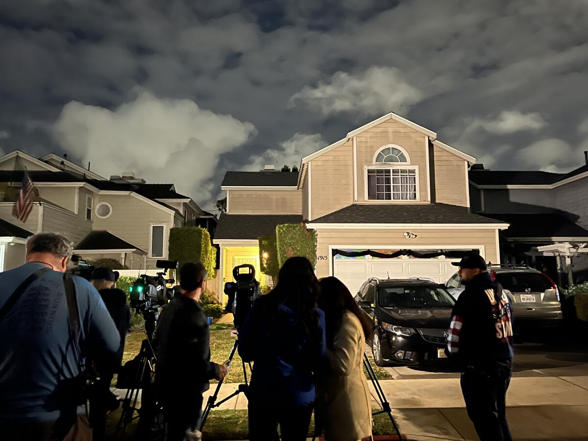 Media gather in front of a house in Torrance