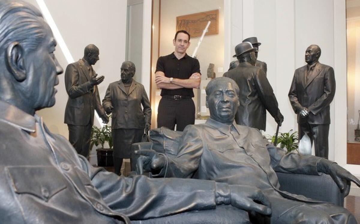 Timothy Naftali, director of the Richard Nixon Presidential Library and Museum in Yorba Linda, stands amid statues in an exhibit called World Leaders, which was installed when the museum was privately owned. Two of the statues -- depicting a seated Chou En-lai, left, and Mao Tse-tung, right -- have raised the hackles of an anti-Communist activist.