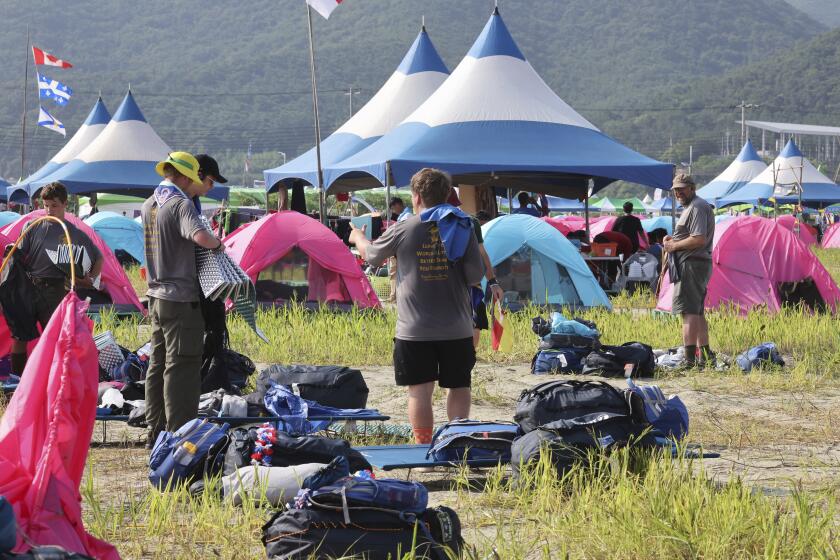 U.S. scout members prepare to leave the World Scout Jamboree campsite in Buan, South Korea, Sunday, Aug. 6, 2023. South Korea is plowing ahead with the World Scout Jamboree, rejecting a call by the world scouting body to cut the event short as a punishing heat wave caused thousands of British scouts to begin leaving the coastal campsite Saturday. American scouts are expected to leave over the weekend. (Na Bo-bae/Yonhap via AP)