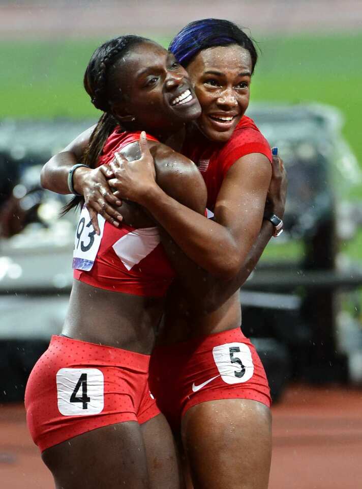Kellie Wells, left, and Dawn Harber celebrate their medals in the 100-meter hurdles.