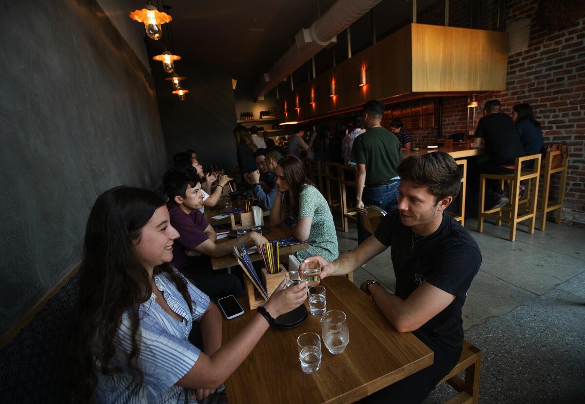 Nicole LaChance and Aaron Kohn toast with sake at Ototo in Echo Park. The interior is snug with six tables and an 11-seat bar.