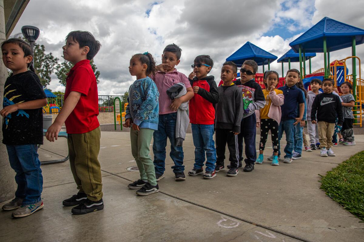Kindergartners line up for class after recess in Pomona last May. 