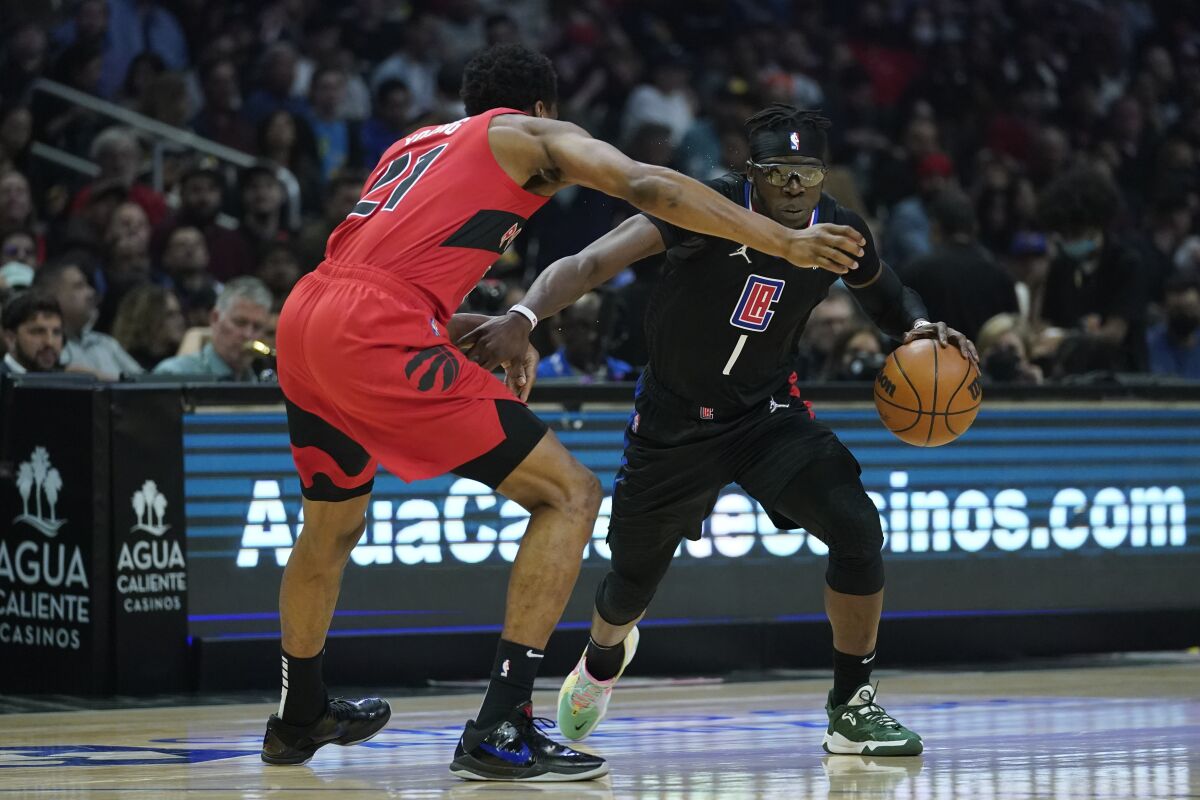 Toronto Raptors forward Thaddeus Young defends against Clippers guard Reggie Jackson.