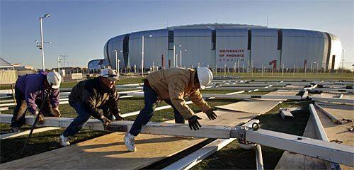 Workers prepare the framework for a canvas tent that will house a kids' area next to the University of Phoenix Stadium, where Super Bowl XLII will be held Feb. 3.