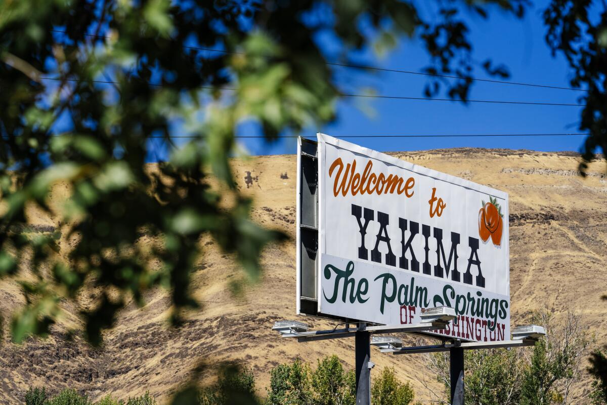 A sign reads "Welcome to Yakima, the Palm Springs of Washington"
