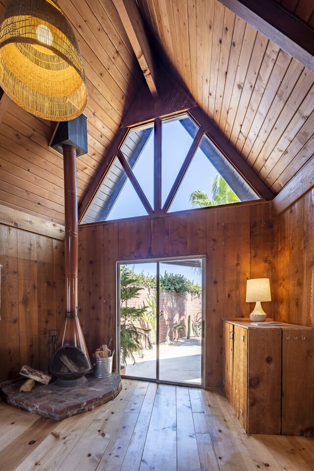 A Midcentury-style fireplace anchors a corner of the guesthouse.