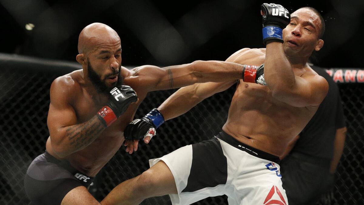 Demetrious Johnson hits John Dodson during their flyweight title mixed martial arts bout at UFC 191 on Sept. 5, 2015, in Las Vegas.