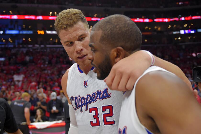 Los Angeles Clippers forward Blake Griffin, left, hugs guard Chris Paul after they defeated the San Antonio Spurs.
