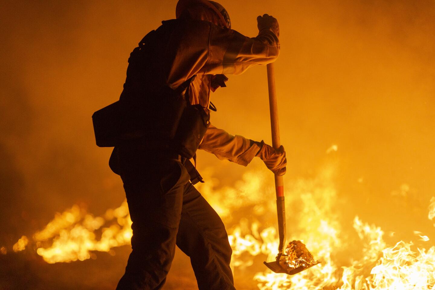 Los Angeles County firefighters, using only hand tools, battle Bobcat fire