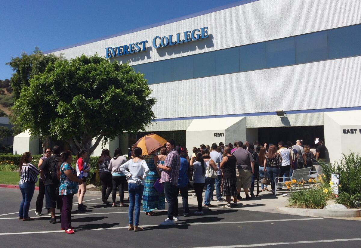 Students wait outside the Everest College located in the City of Industry on April 28, hoping to get their transcripts and information on loan forgiveness and transferring credits to other schools.