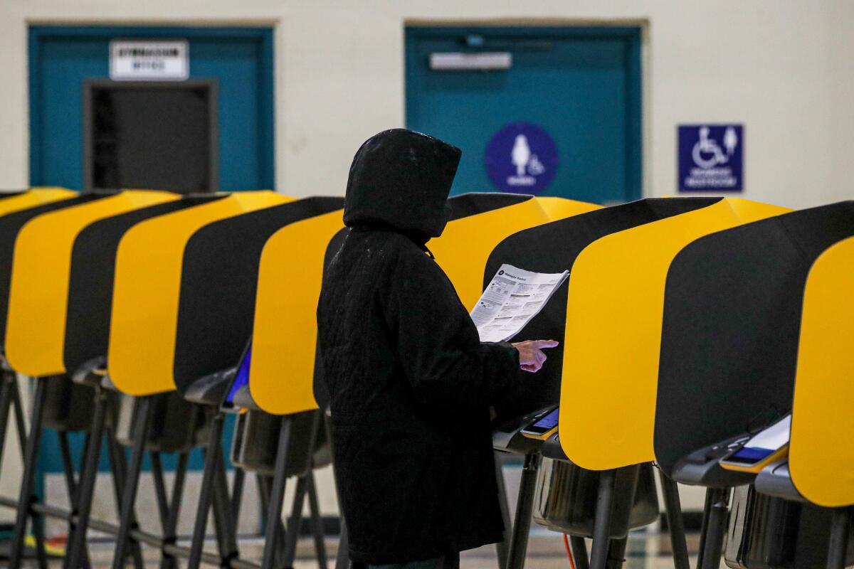 A voter reviews her ballot inside a polling station