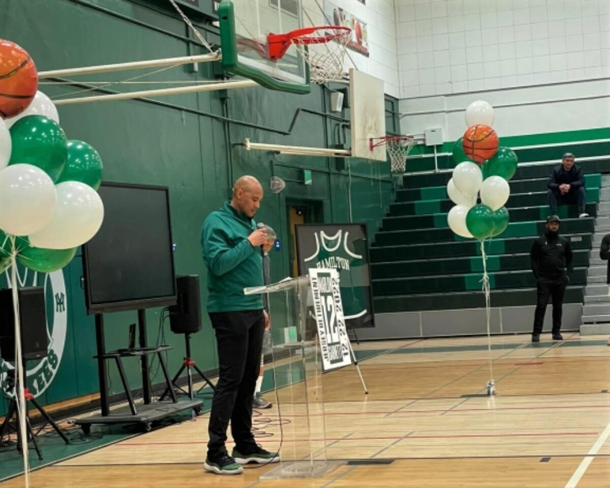 Marlon Garnett addresses spectators at Hamilton High during a ceremony to retire his uniform number.