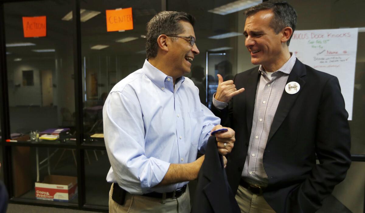 LAS VEGAS - Xavier Becerra (CA-34), a U.S. Representative of Los Angeles and Chairman of the House Democratic Caucus talk briefly with Los Angeles Mayor Eric Garcetti, right, at a rally with SEIU members in Las Vegas. (Francine Orr/ Los Angeles Times)