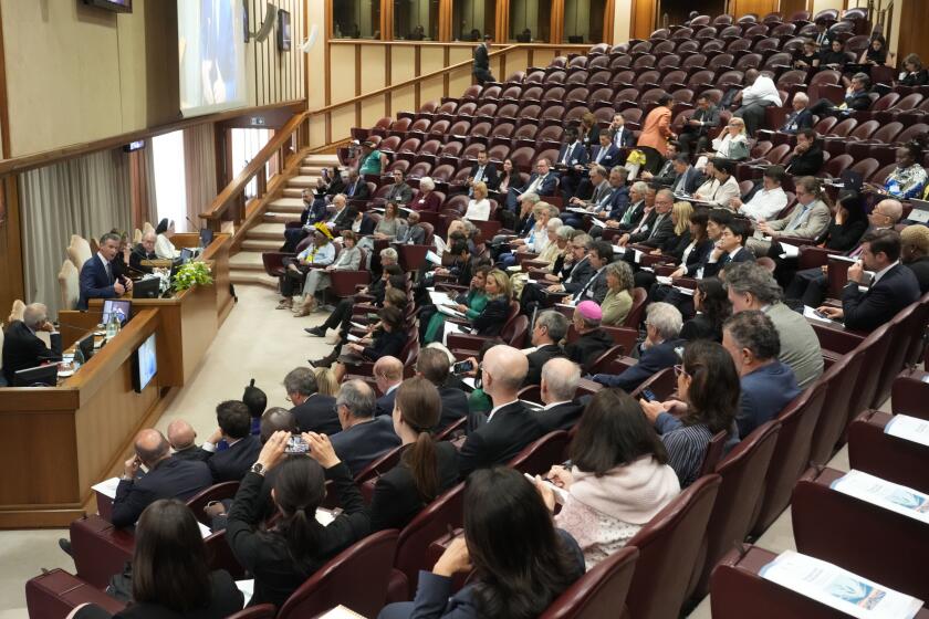 Governor of California, Gavin Newsom, left, delivers his speech during the "From Climate Crisis to Climate Resilience" 3-day summit organized by The Pontifical Academy of Sciences at The Vatican, Thursday, May 16, 2024. (AP Photo/Gregorio Borgia)