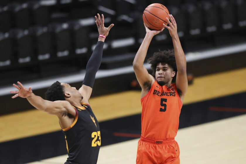 Oregon State's Ethan Thompson (5) shoots over Arizona State's Marcus Bagley (23) during the first half of an NCAA college basketball game in Corvallis, Ore., Saturday, Jan. 16, 2021. (AP Photo/Amanda Loman)