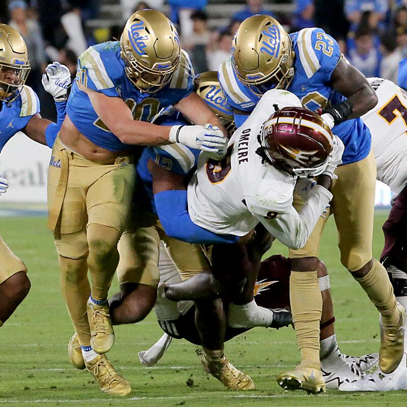 Pasadena, CA - THe UCLA defense puts the clamps on ASU wide receiver Troy Omeire.