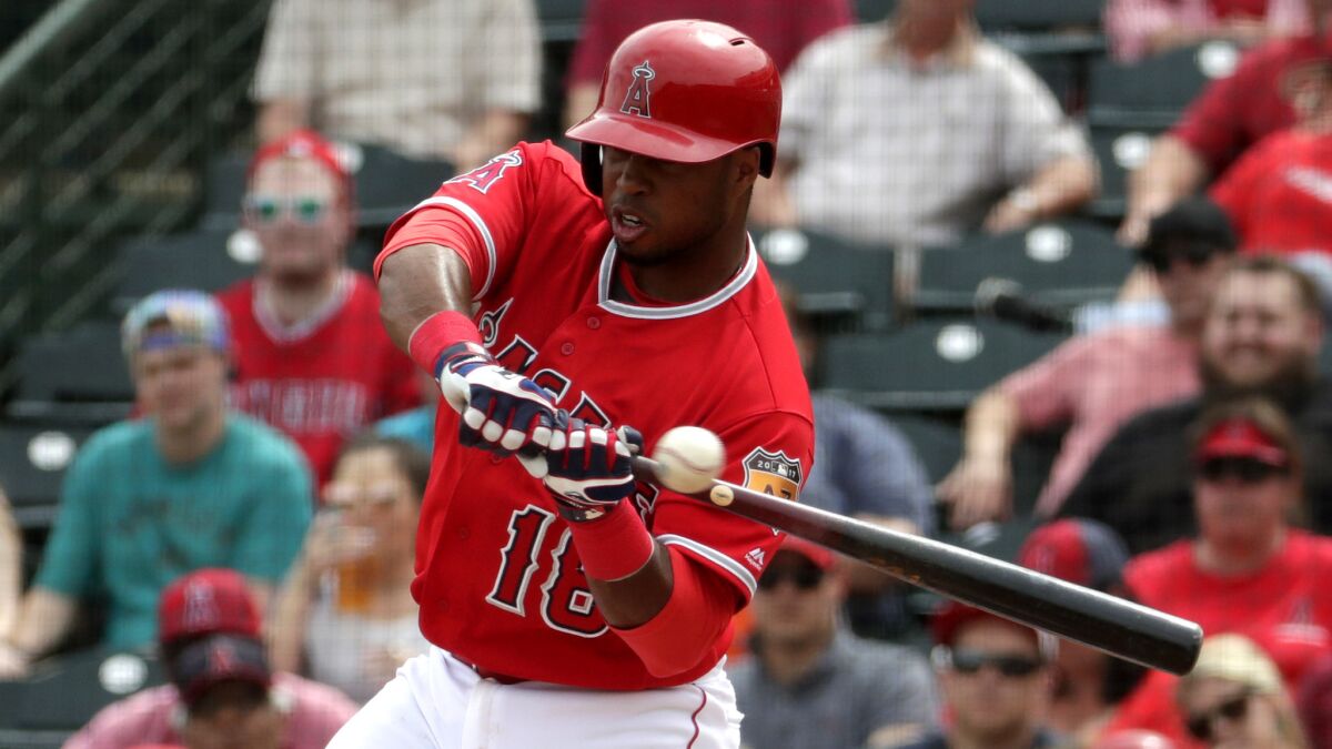 Luis Valbuena takes a cut during the Angels' exhibition game Wednesday. He would leave in the third inning because of a strained right hamstring.