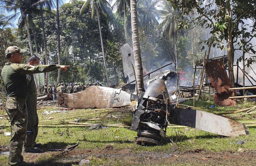 In this photo released by the Joint Task Force - Sulu, parts of a Lockheed C-130 Hercules plane are seen at the crash site in Patikul town, Sulu province, southern Philippines, Sunday July 4, 2021. Philippine troops found the last five dead from the crash of the transport aircraft in the south, raising the death toll to 50 in the military's worst air disaster, officials said Monday. (Joint Task Force-Sulu via AP)