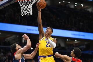 Los Angeles Lakers forward Rui Hachimura scores against Washington Wizards forward Anthony Gill, left, and guard Jordan Poole during the second half of an NBA basketball game Wednesday, April 3, 2024, in Washington. (AP Photo/John McDonnell)