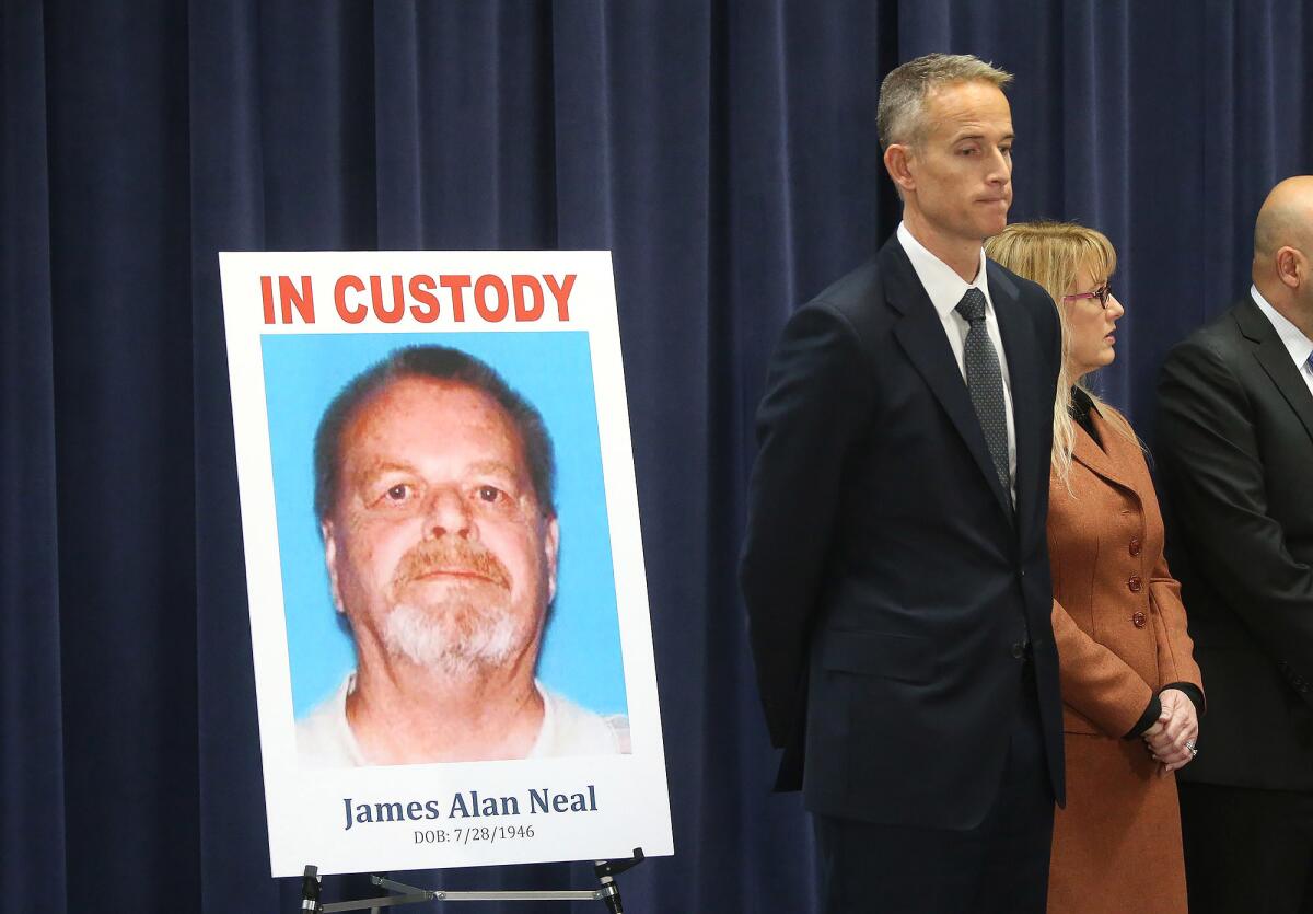 Senior Deputy Dist. Atty. Matt Murphy stands next to picture of James Alan Neal, who was arrested in the cold case killing of Linda Ann O'Keefe.