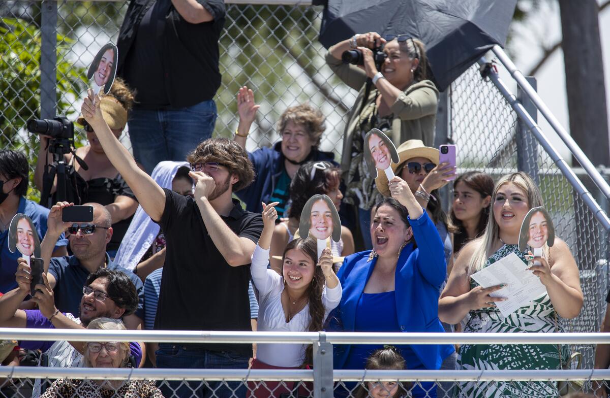 Family members cheer on their graduate from the stands during Costa Mesa High's commencement ceremony Thursday.