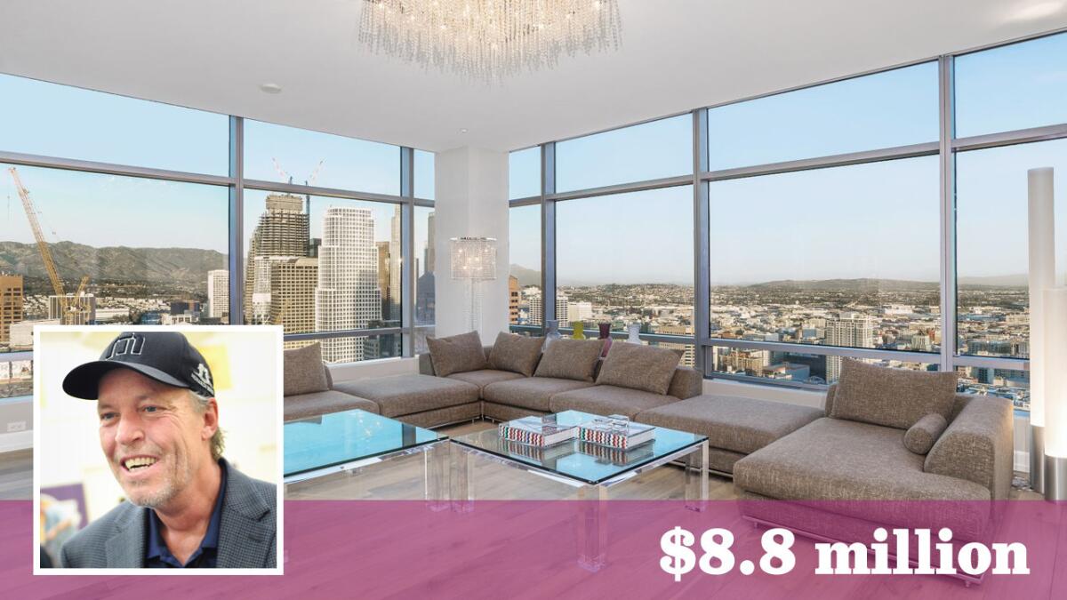 Lakers co-owner Jim Buss has put a corner penthouse in downtown Los Angeles on the market for $8.8 million.